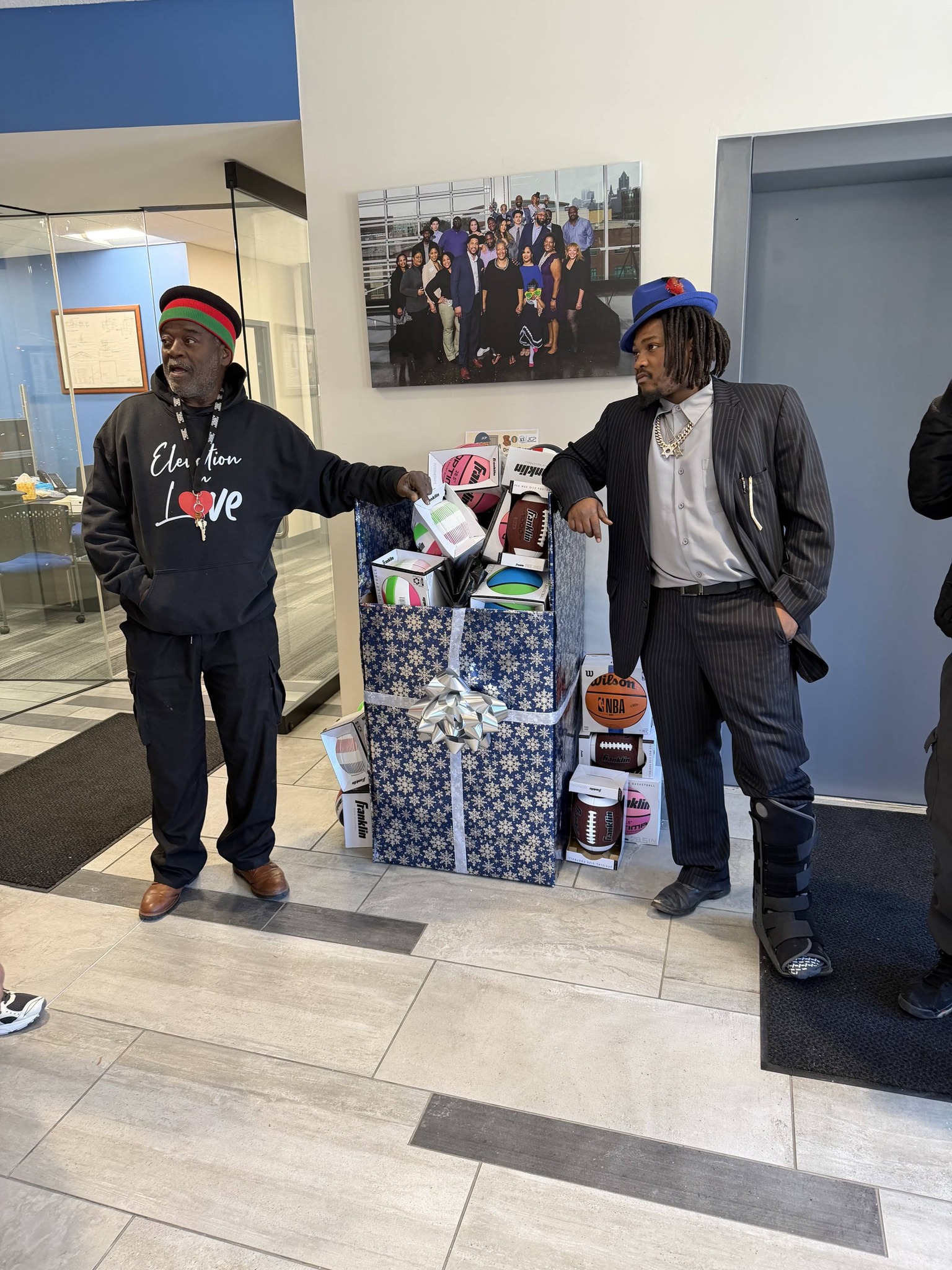 Two CAGE MKE members with donated gifts