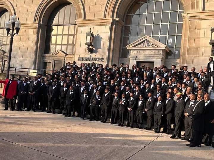 Hundreds of men and boys in tuxedos filling courthouse steps